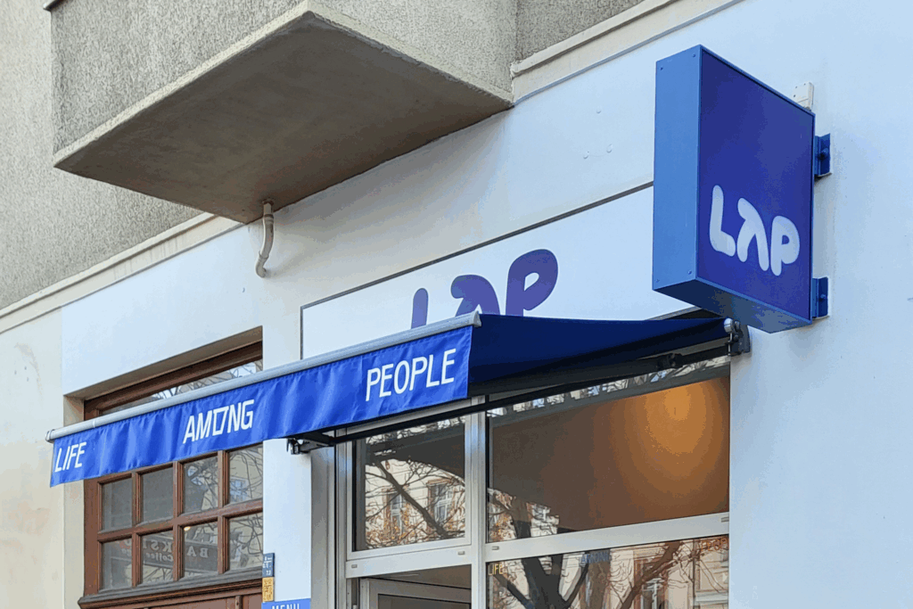 Wie LAP Coffee Design zur Strategie macht – und auf Kritik mit Kommunikation reagiert Außenansicht von LAP Coffee in Berlin – modernes Café mit minimalistischem Design in Blau und Weiß